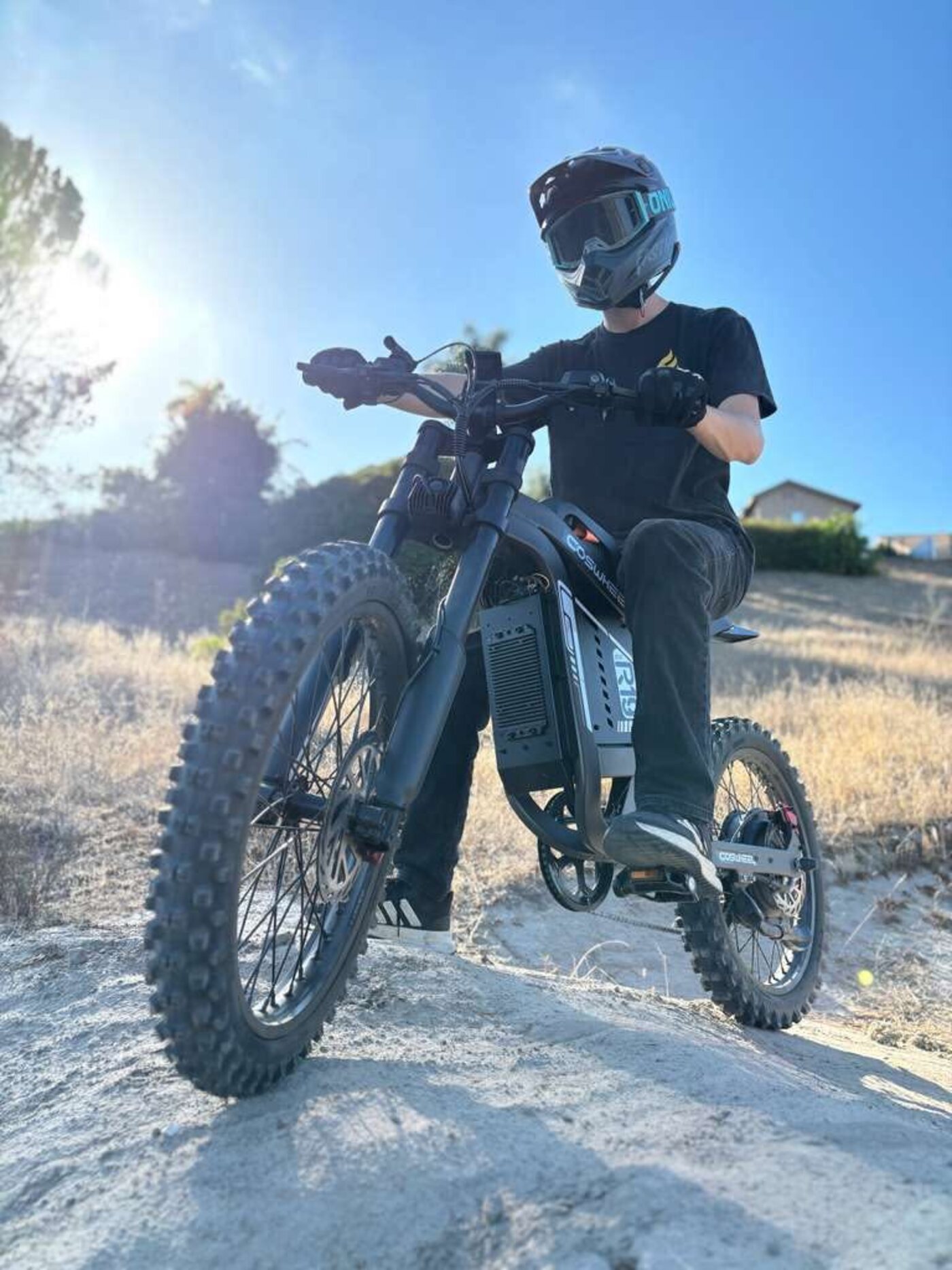 COSWHEEL electric dirt bike on a hillside trail