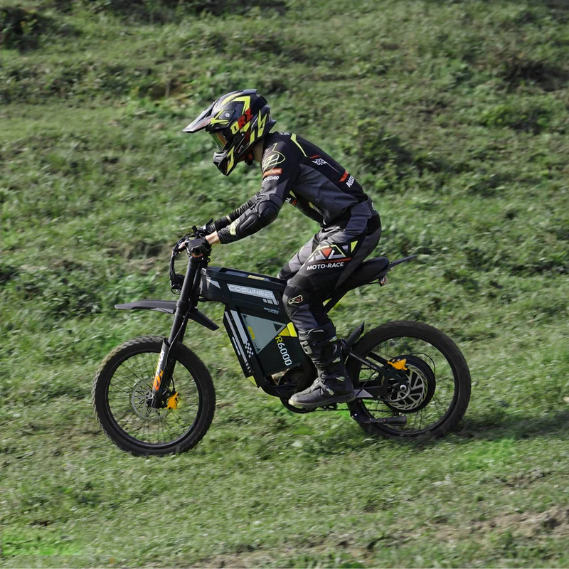 COSWHEEL R6000 climbing a grass hill in full moto gear