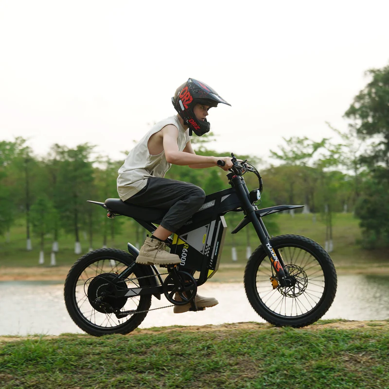 Rider standing on the COSWHEEL R6000 beside a lake